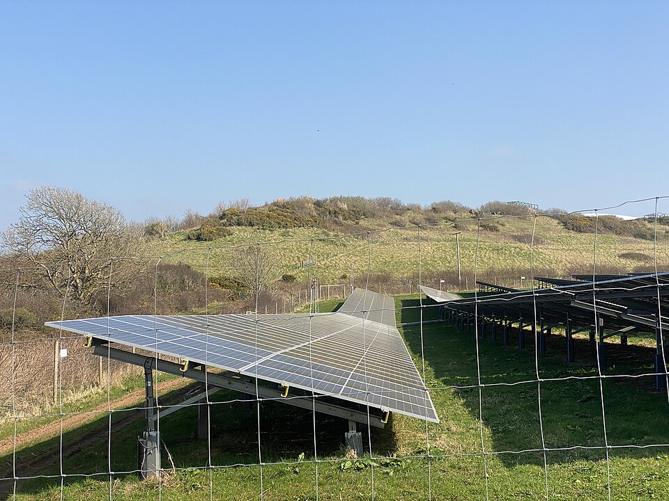 An array of solar panels in a field