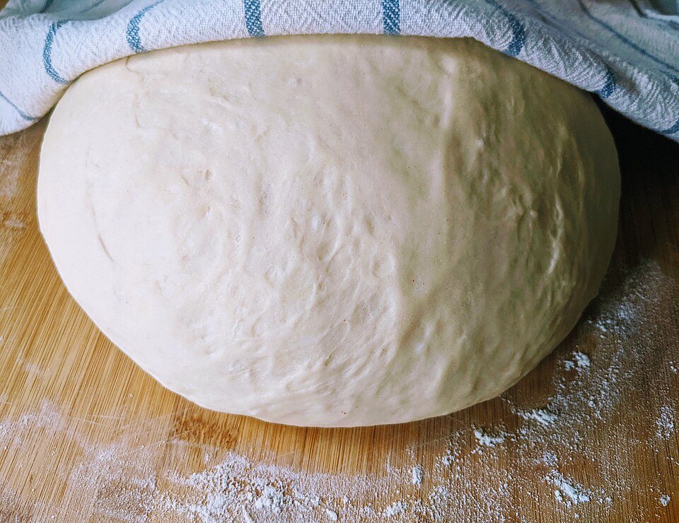 Risen bread dough in a bowl